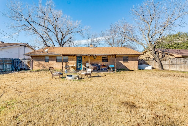 back of property featuring a yard and a patio