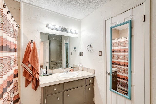 bathroom with vanity and a textured ceiling