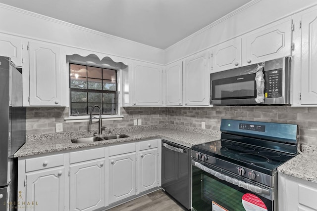 kitchen with white cabinetry, sink, tasteful backsplash, and stainless steel appliances