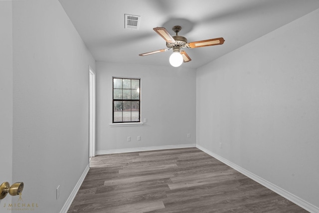 spare room with hardwood / wood-style flooring and ceiling fan