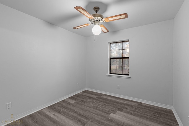 spare room featuring dark hardwood / wood-style floors and ceiling fan