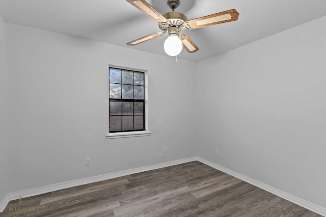 unfurnished room with dark hardwood / wood-style flooring and ceiling fan