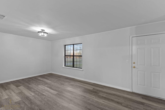 unfurnished room featuring crown molding and wood-type flooring