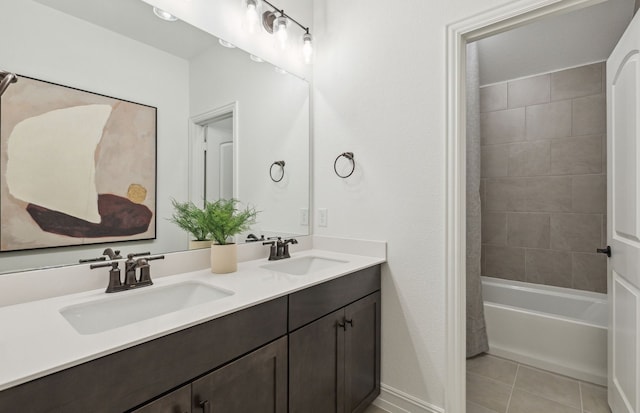 bathroom featuring tile patterned floors, tiled shower / bath combo, and vanity