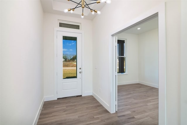 foyer entrance featuring light wood-type flooring and an inviting chandelier