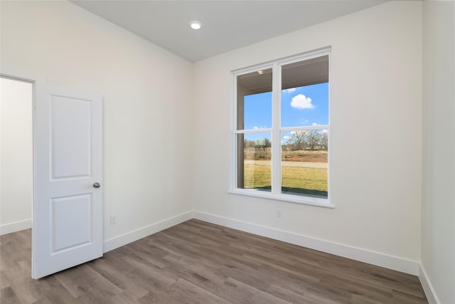 empty room with hardwood / wood-style flooring