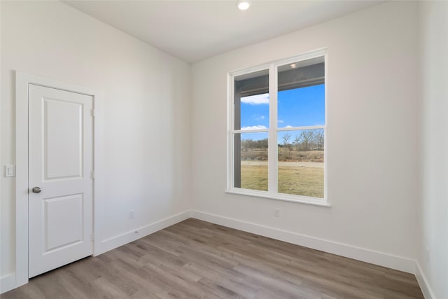 unfurnished room with light hardwood / wood-style flooring