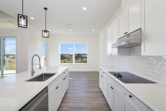 kitchen featuring decorative light fixtures, dishwasher, white cabinetry, sink, and black electric cooktop