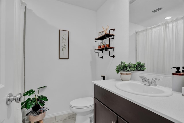 bathroom with tile patterned floors, vanity, and toilet