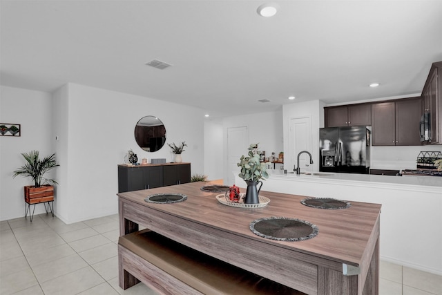 dining area with light tile patterned floors and sink