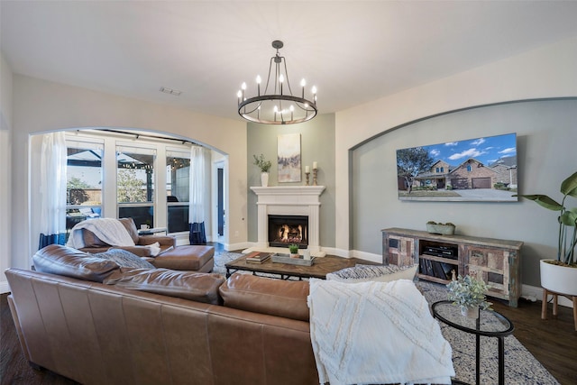 living room with a chandelier and dark hardwood / wood-style flooring