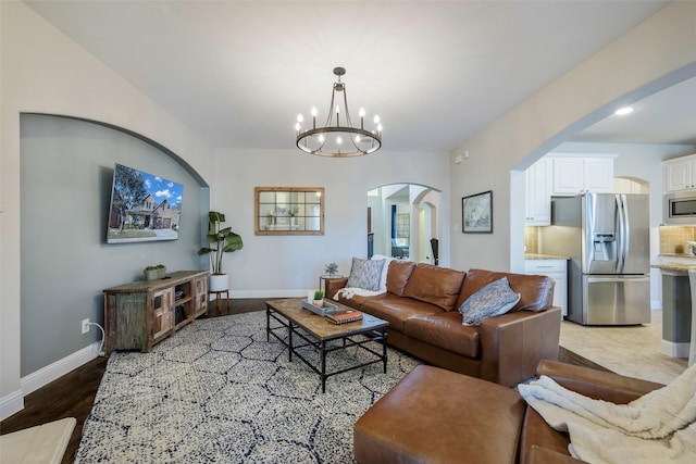 living room featuring hardwood / wood-style floors and a notable chandelier