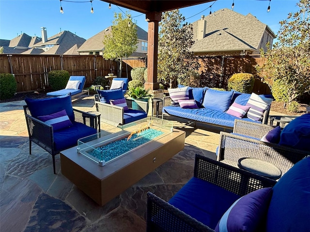 view of patio / terrace with an outdoor living space with a fire pit