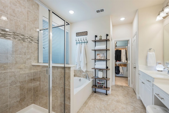 bathroom featuring a healthy amount of sunlight, vanity, and independent shower and bath