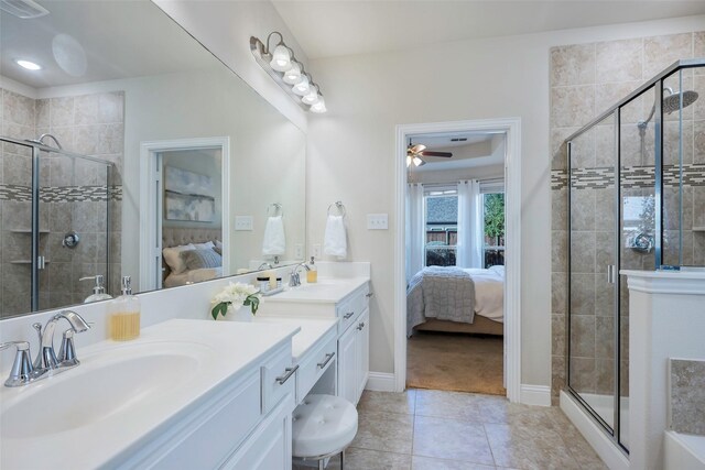 bathroom with tile patterned flooring, vanity, a shower with door, and ceiling fan