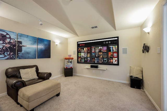 home theater featuring light carpet and vaulted ceiling