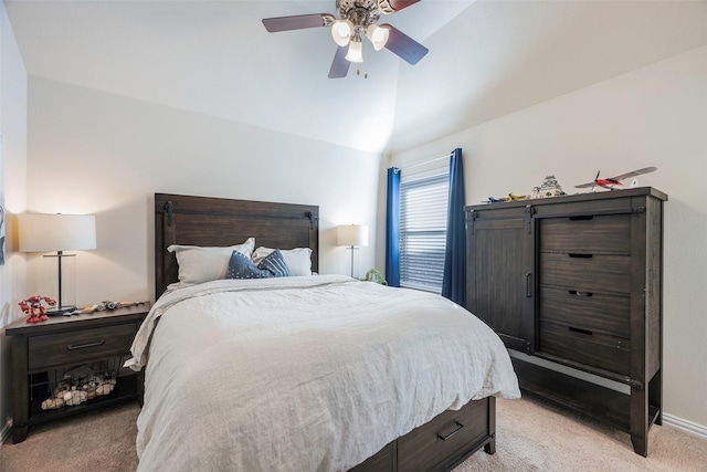 bedroom with ceiling fan, light carpet, and vaulted ceiling