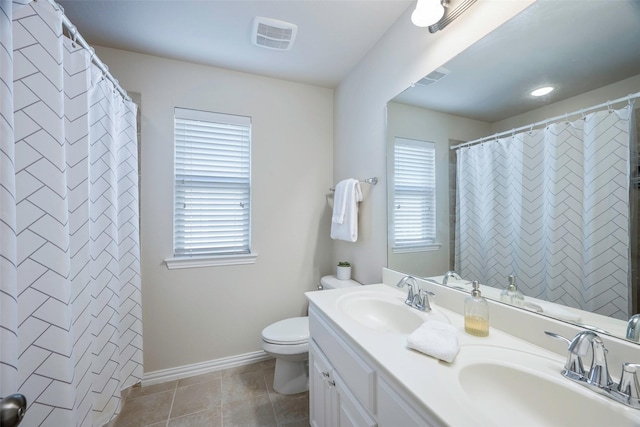 bathroom with tile patterned floors, vanity, toilet, and curtained shower