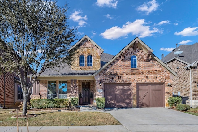 view of front of property featuring a front yard and a garage