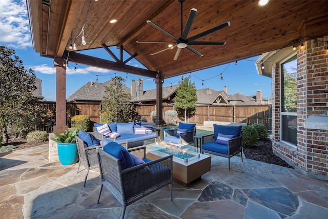 view of patio / terrace with a gazebo, ceiling fan, and an outdoor living space with a fire pit