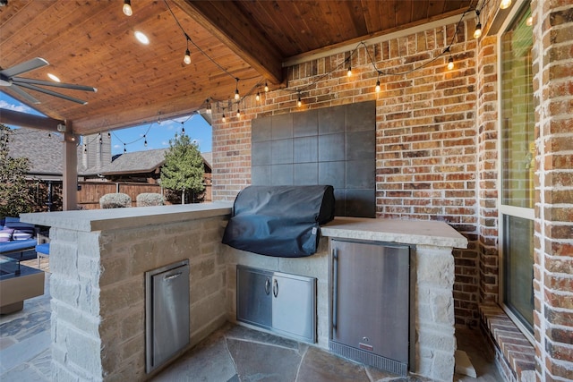 view of patio featuring an outdoor kitchen, grilling area, and ceiling fan