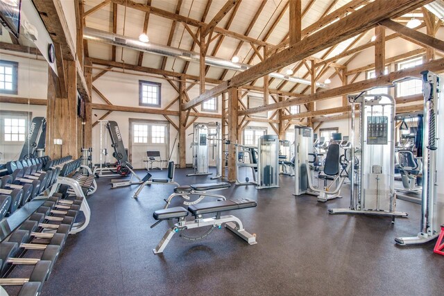 exercise room with high vaulted ceiling