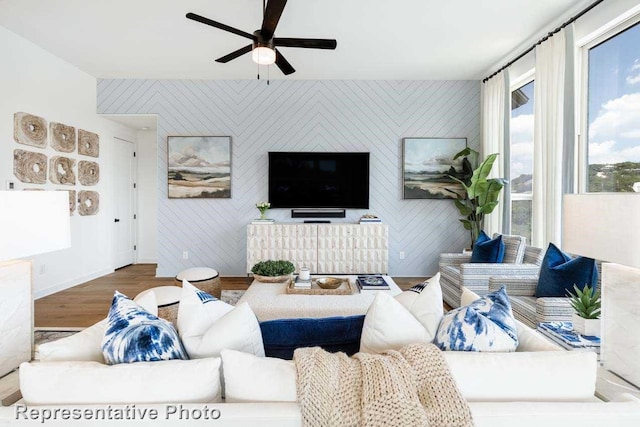 living room with hardwood / wood-style flooring and ceiling fan