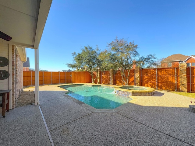 view of swimming pool with an in ground hot tub and a patio