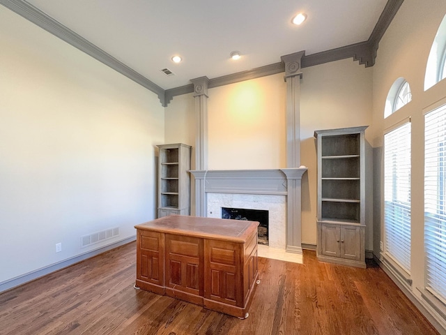 home office featuring a high end fireplace, dark hardwood / wood-style flooring, and a wealth of natural light