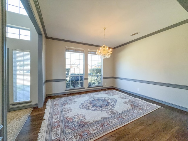 unfurnished dining area featuring crown molding, a notable chandelier, dark wood-type flooring, and a wealth of natural light