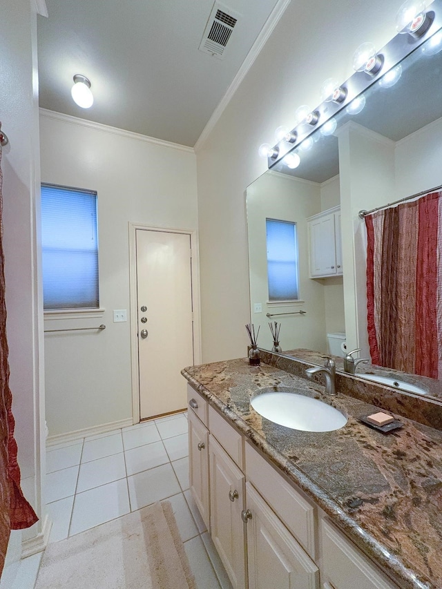 bathroom featuring vanity, crown molding, tile patterned floors, and toilet