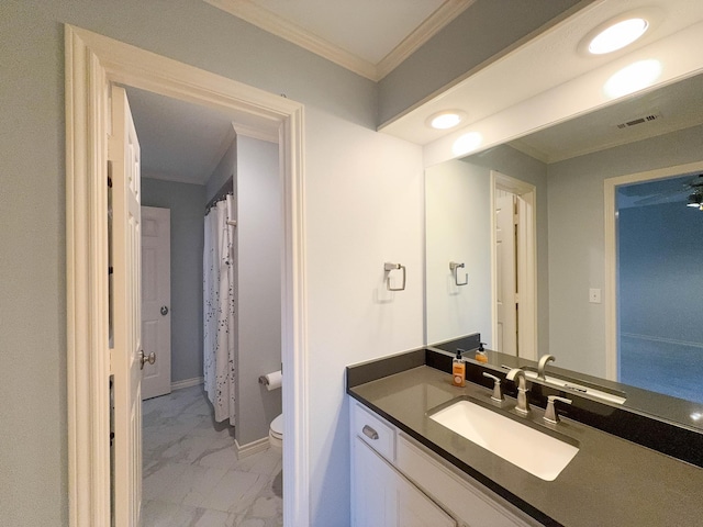 bathroom featuring vanity, crown molding, and toilet