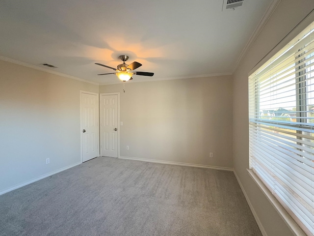 unfurnished room with ceiling fan, ornamental molding, and carpet floors