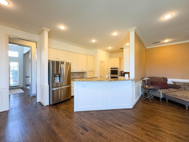 kitchen featuring white cabinetry, dark wood-type flooring, kitchen peninsula, and appliances with stainless steel finishes