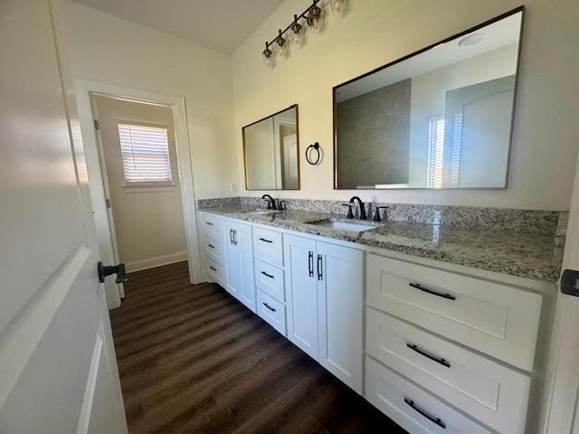 bathroom with vanity and hardwood / wood-style flooring