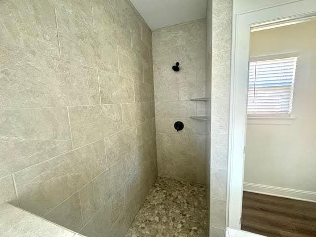 bathroom with tiled shower