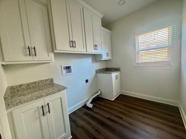 washroom featuring dark hardwood / wood-style flooring, cabinets, and washer hookup