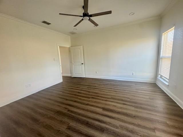 spare room featuring dark hardwood / wood-style floors, ceiling fan, and ornamental molding