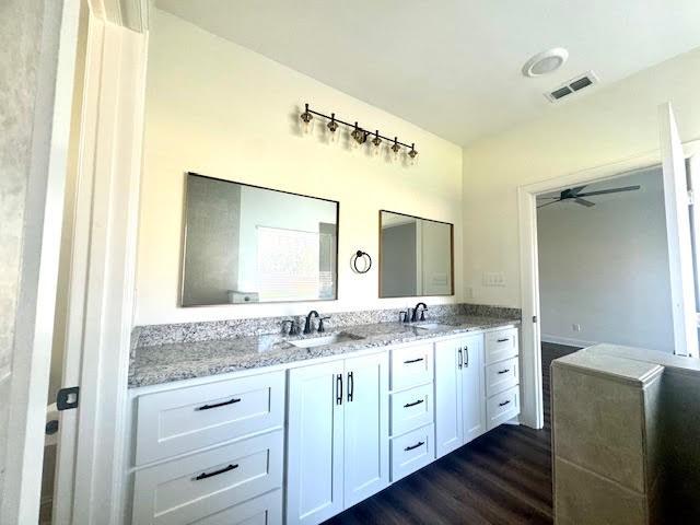 bathroom featuring hardwood / wood-style flooring, ceiling fan, and vanity