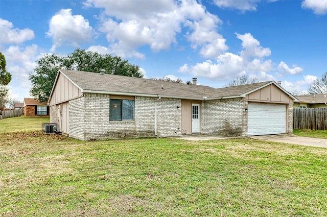 ranch-style house with a front yard, central AC, and a garage