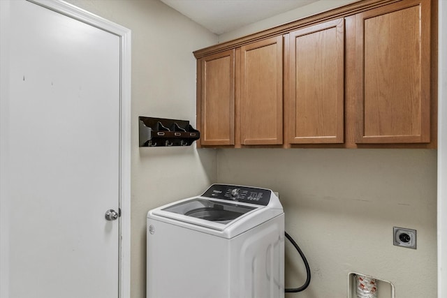 laundry area with cabinets and washer / dryer