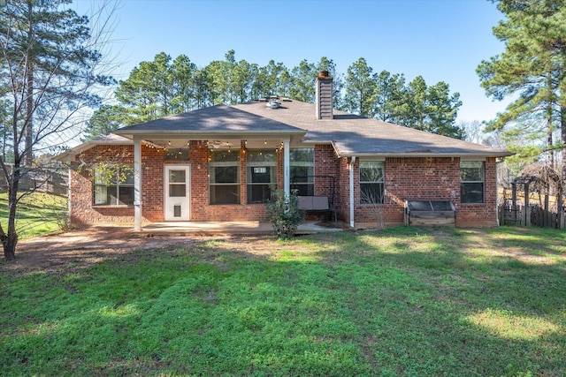 back of house featuring a lawn