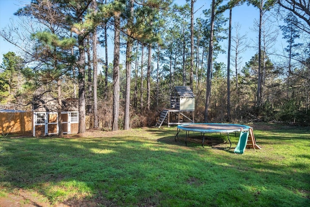 view of yard featuring a shed and a trampoline