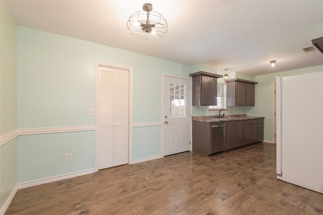 kitchen with dark wood-type flooring, stainless steel dishwasher, dark brown cabinetry, and sink