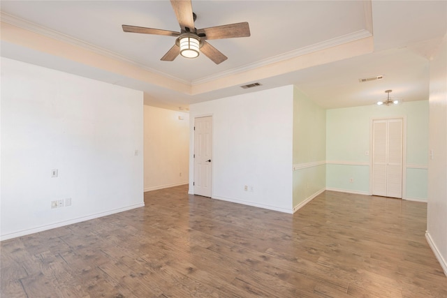 309 Rock Ct, Princeton, TX 75407 - unfurnished room with wood finished floors, visible vents, crown molding, a ceiling fan, and a raised ceiling