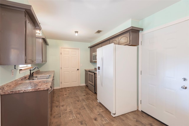 309 Rock Ct, Princeton, TX 75407 - kitchen with dark wood finished floors, gray cabinetry, appliances with stainless steel finishes, and baseboards