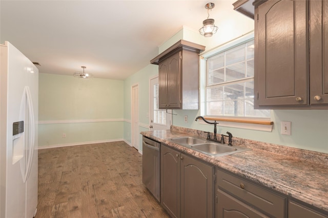 kitchen featuring sink, dark brown cabinets, stainless steel dishwasher, dark hardwood / wood-style floors, and white refrigerator with ice dispenser