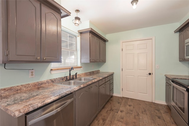 309 Rock Ct, Princeton, TX 75407 - kitchen with white fridge with ice dispenser, stainless steel dishwasher, baseboards, a sink, and dark wood-style floors