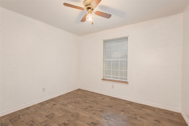 spare room with dark wood-type flooring and ceiling fan