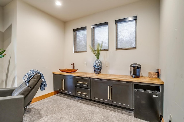 bar with butcher block counters and refrigerator